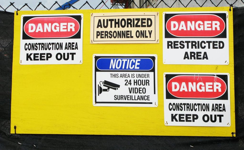 contractor signs posted on a construction site board